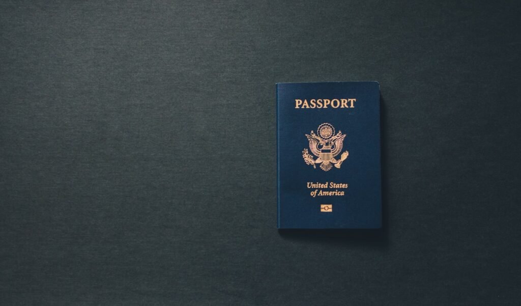 A passport on a desk representing the O-1 visa vs EB-1A green card decision