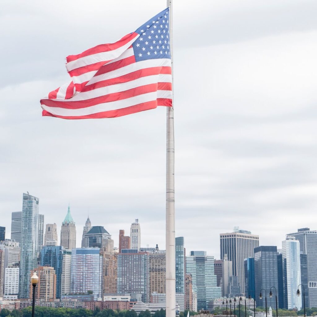 U.S. flag representing the O-1 visa without an employer through a U.S. agent petitioner